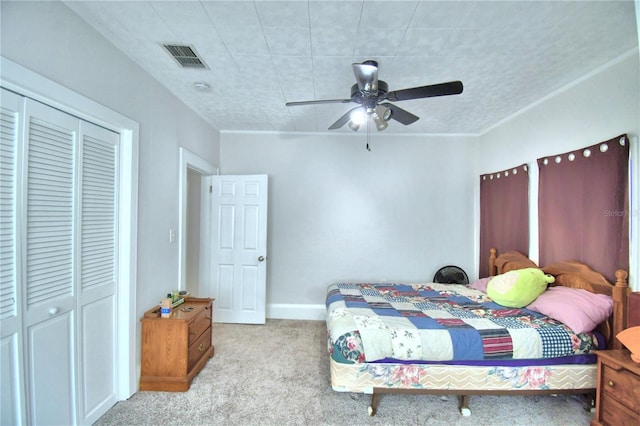 bedroom with ceiling fan, a closet, and light carpet