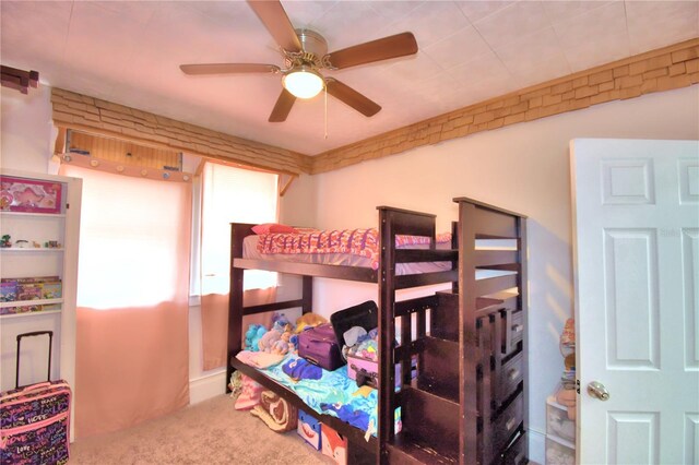 bedroom featuring ceiling fan, carpet floors, and multiple windows