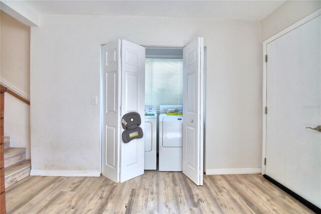 entryway featuring light wood-type flooring and independent washer and dryer