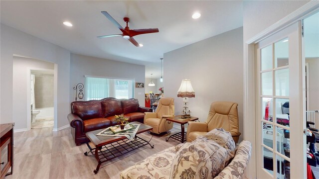 living room with ceiling fan and light wood-type flooring