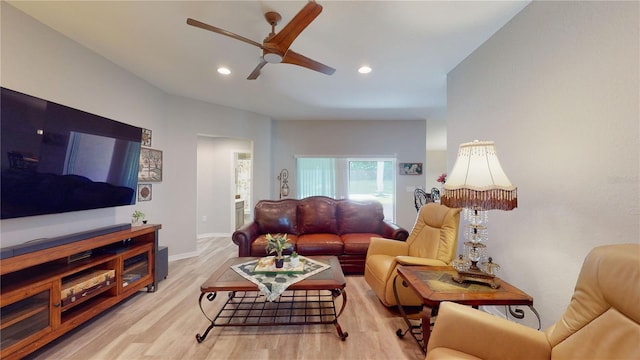 living room featuring light wood-type flooring and ceiling fan