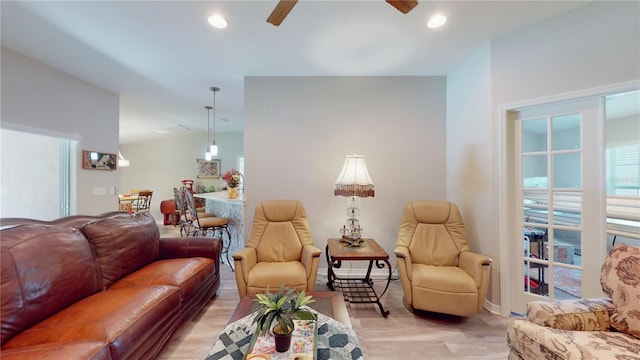 living room featuring ceiling fan and light hardwood / wood-style floors