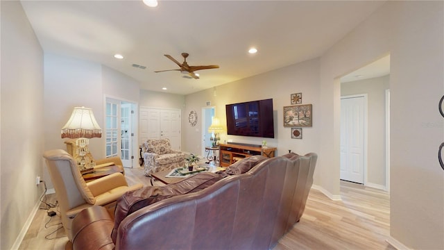 living room featuring light hardwood / wood-style flooring, ceiling fan, and french doors