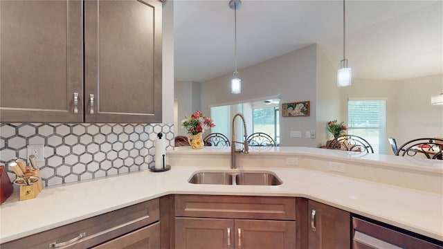 kitchen featuring sink, tasteful backsplash, and decorative light fixtures