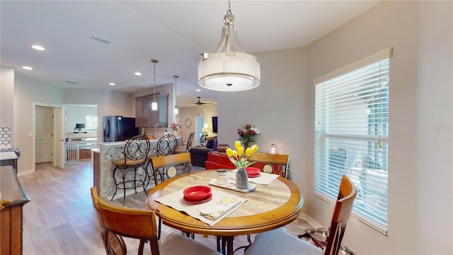 dining room featuring light hardwood / wood-style floors and ceiling fan