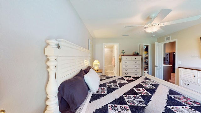 bedroom with stainless steel fridge, ceiling fan, connected bathroom, and hardwood / wood-style flooring