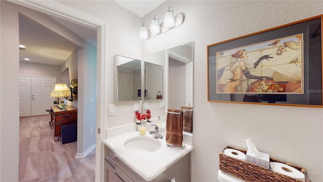 bathroom featuring vanity and wood-type flooring