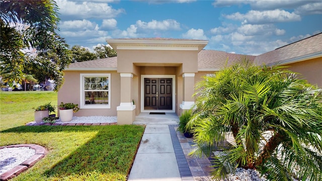 doorway to property featuring a lawn