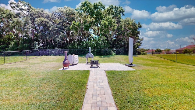 view of yard featuring an outdoor fire pit and a patio area