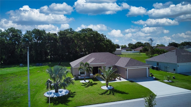 ranch-style home with a front yard and a garage