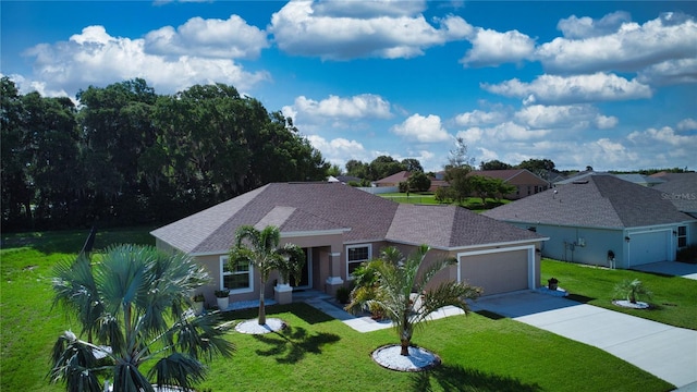 ranch-style house featuring a garage and a front lawn