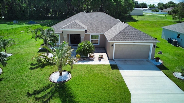 view of front of house featuring a garage and a front lawn