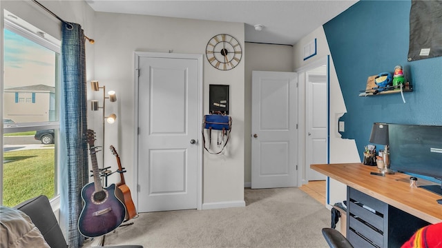 carpeted home office featuring visible vents and baseboards