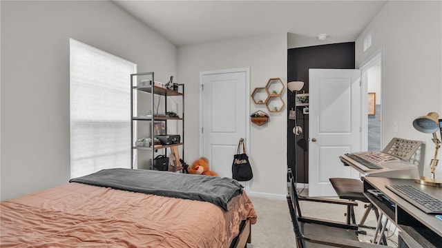 bedroom featuring carpet floors, visible vents, and baseboards