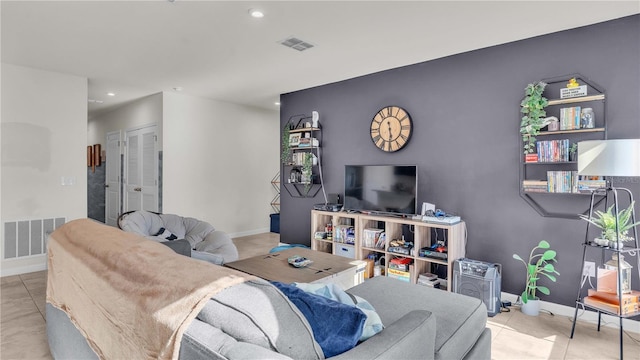 tiled living area with recessed lighting, visible vents, and baseboards