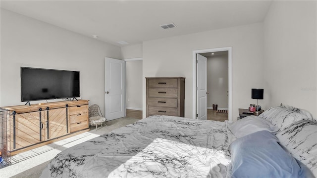 bedroom with baseboards, visible vents, and light colored carpet