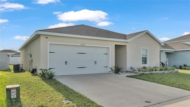 ranch-style house featuring a front yard, central AC, an attached garage, and stucco siding