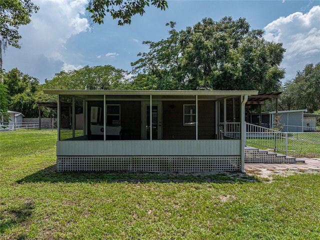 rear view of property with a yard