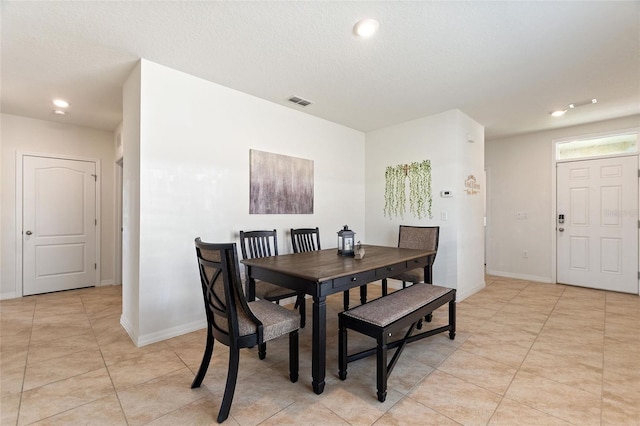 dining area with light tile patterned floors