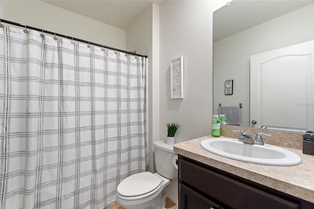 bathroom featuring toilet and vanity