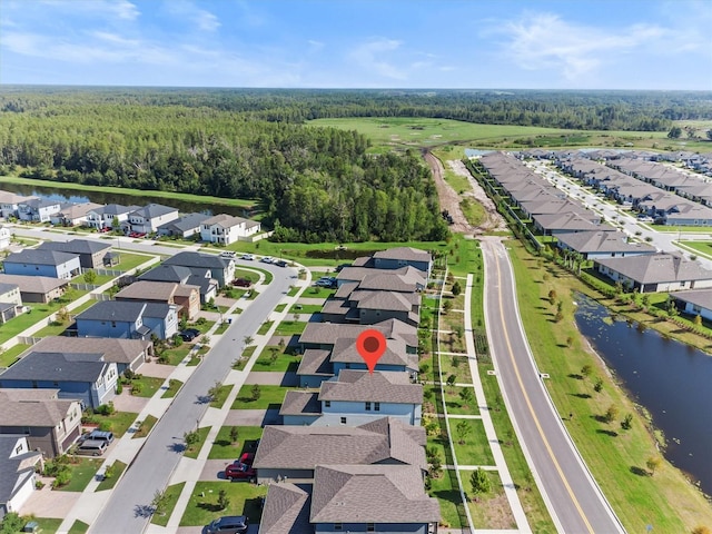 9681 Flourish Dr, Land O Lakes, FL 34637 - aerial view of residential area featuring a heavily wooded area and a large body of water