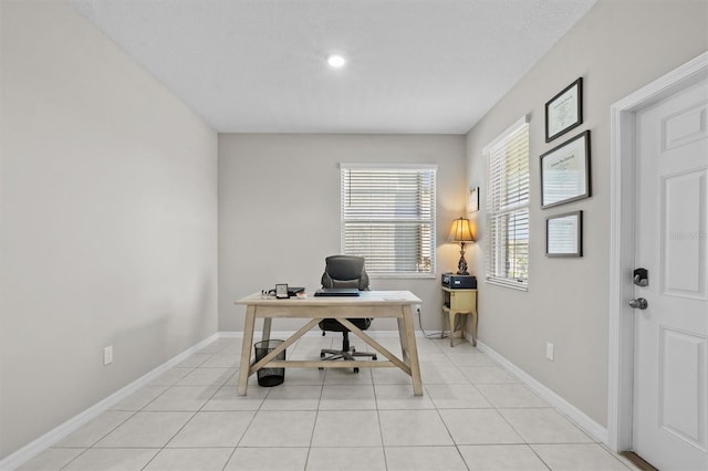 office space with light tile patterned floors and baseboards