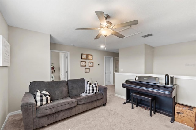 living room with light carpet, baseboards, visible vents, and ceiling fan