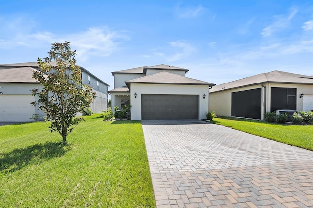 9681 Flourish Dr, Land O Lakes, FL 34637 - view of front facade with decorative driveway, a front yard, an attached garage, and stucco siding