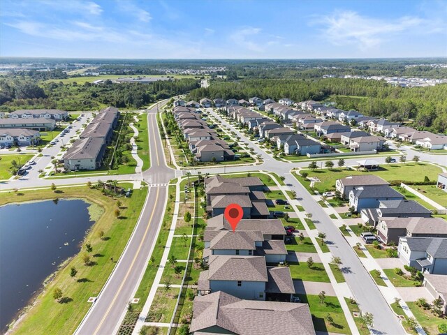 birds eye view of property with a water view and a residential view