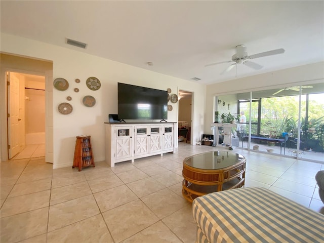 living room featuring light tile patterned floors and ceiling fan