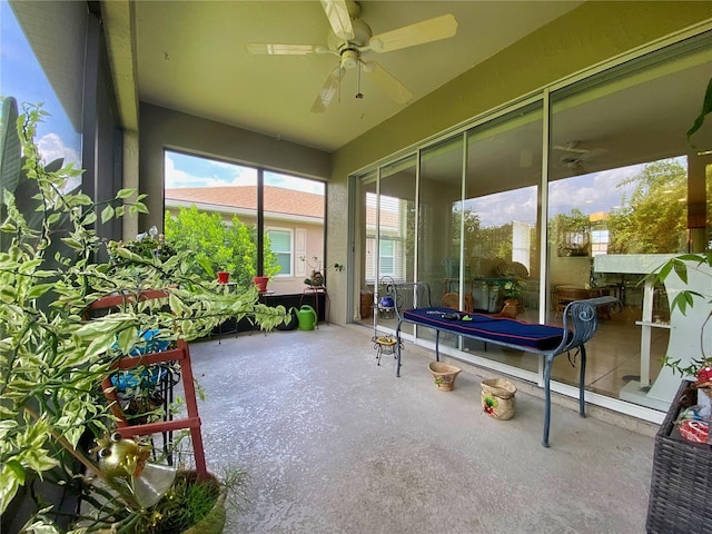 sunroom / solarium featuring ceiling fan