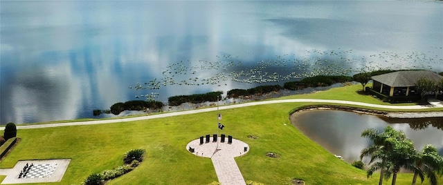 view of home's community with a yard and a water view