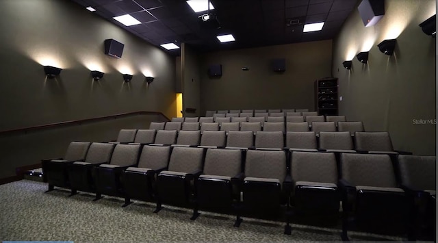 carpeted cinema with a drop ceiling