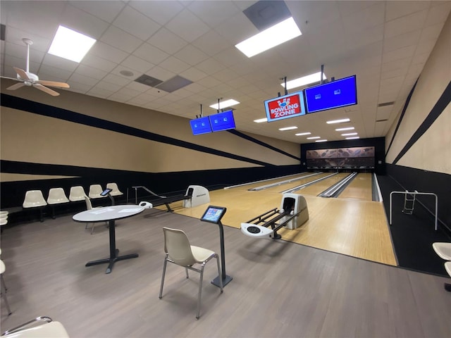 game room featuring a paneled ceiling, ceiling fan, and hardwood / wood-style floors