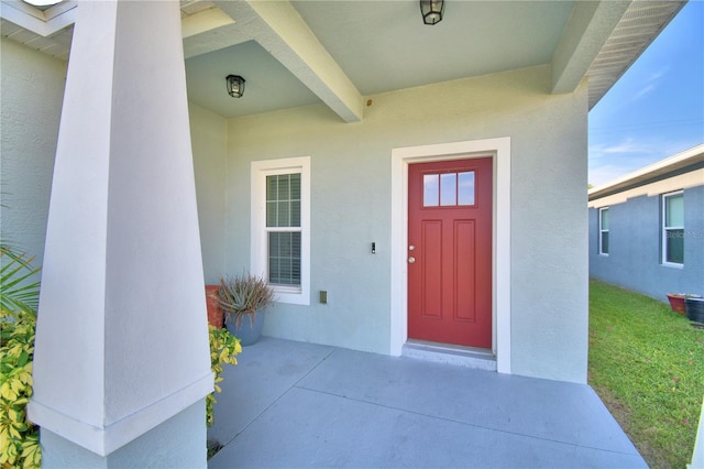 entrance to property featuring a yard