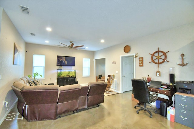 interior space with ceiling fan and concrete floors