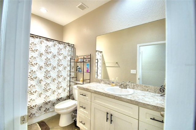 bathroom featuring tile patterned floors, vanity, and toilet