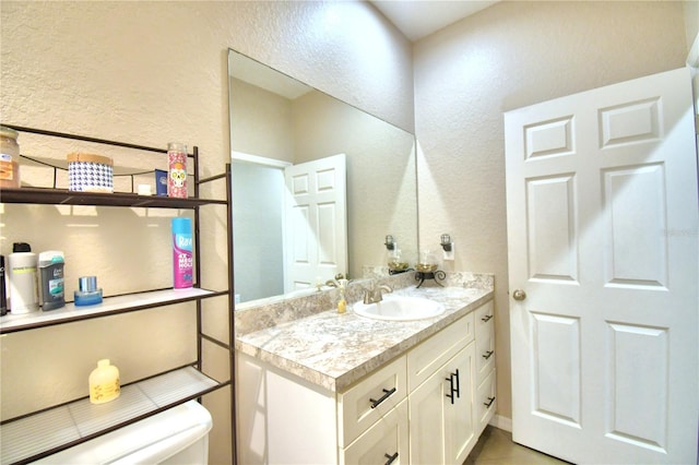 bathroom featuring toilet and vanity