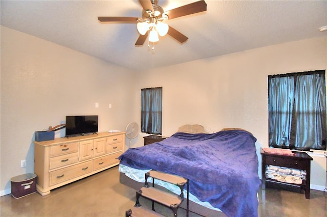 bedroom featuring ceiling fan and a textured ceiling