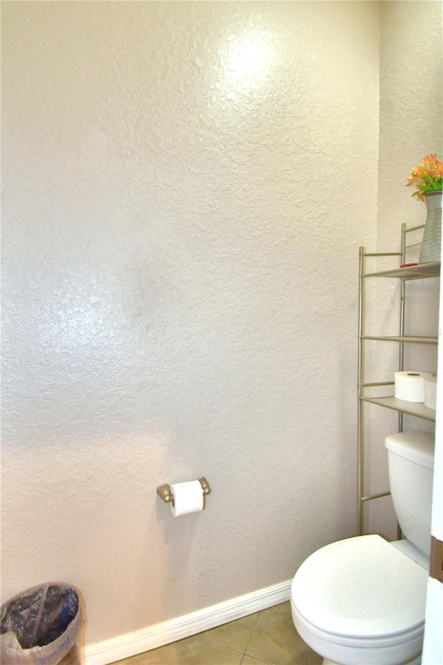 bathroom with tile patterned flooring and toilet