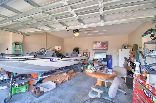 garage featuring a garage door opener and white fridge