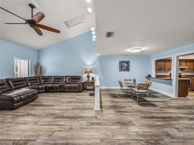 living room featuring ceiling fan, lofted ceiling, and hardwood / wood-style floors