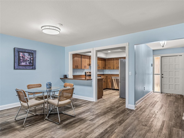 dining area with dark hardwood / wood-style flooring