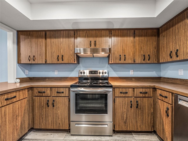 kitchen with appliances with stainless steel finishes and light hardwood / wood-style flooring