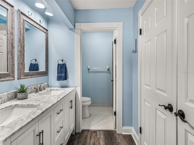 bathroom featuring tile patterned flooring, toilet, and vanity