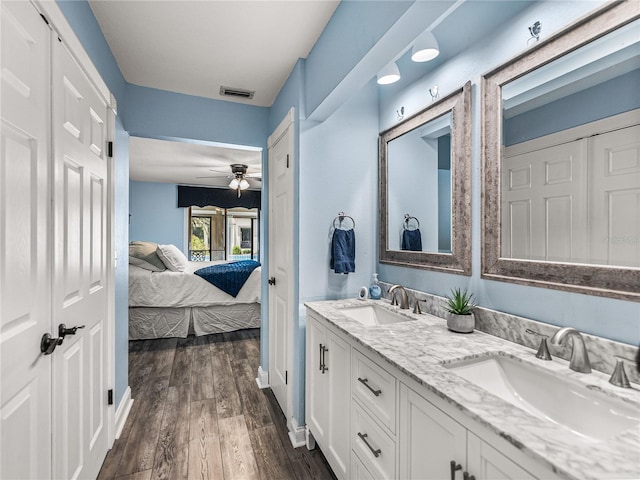 bathroom featuring ceiling fan, vanity, and wood-type flooring