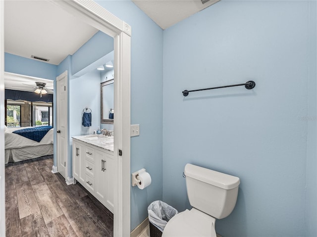 bathroom featuring ceiling fan, toilet, hardwood / wood-style floors, and vanity