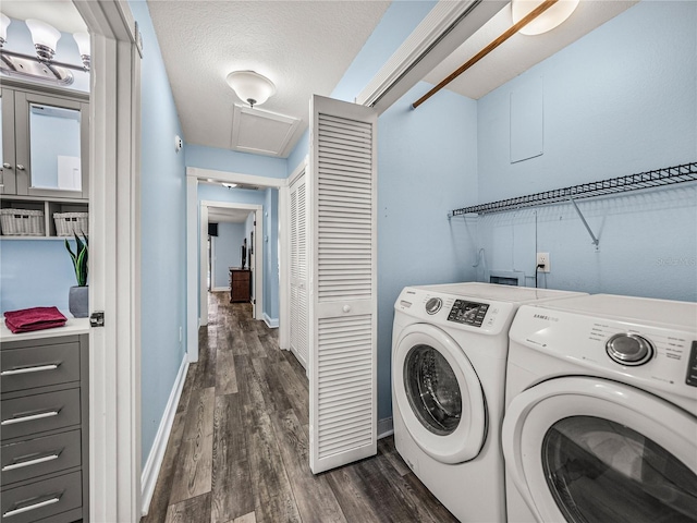 washroom featuring independent washer and dryer, dark hardwood / wood-style flooring, and a textured ceiling