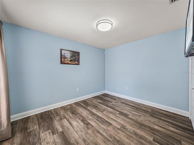 spare room with hardwood / wood-style flooring