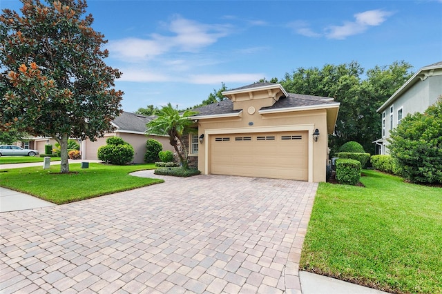 view of front of home with a garage and a front lawn